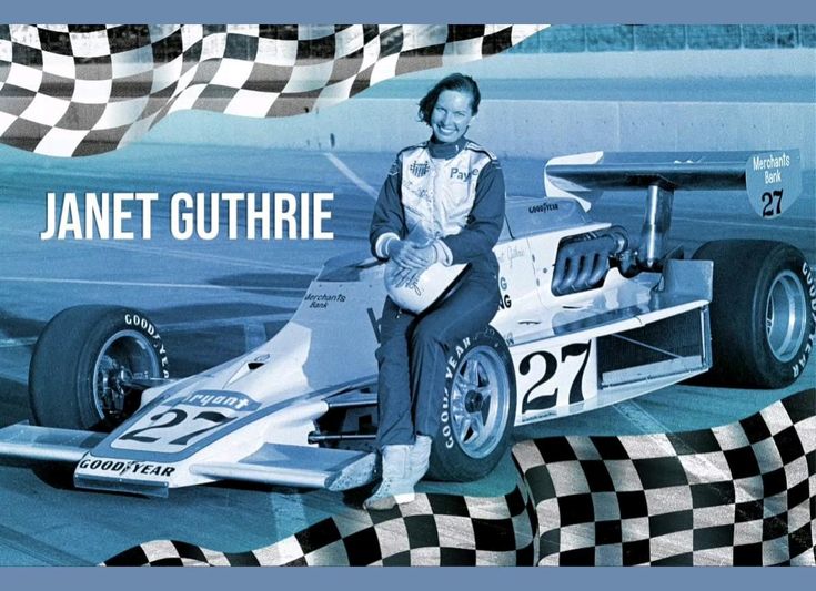 Race car driver posing with Formula car number 27, surrounded by checkered flags.