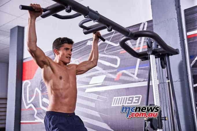 Man performing pull-ups on a gym bar, focusing on fitness.