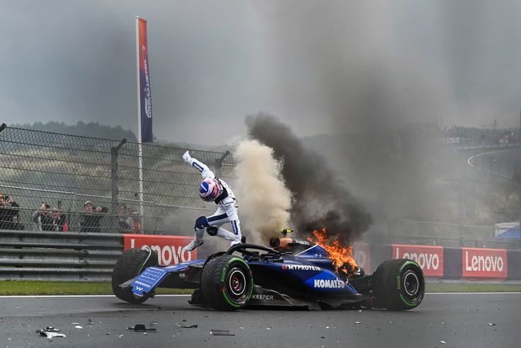Racing driver escapes burning F1 car during dramatic track incident.