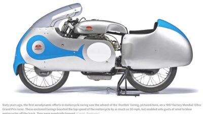 Vintage 1957 Mondial 125cc Grand Prix race motorcycle with aerodynamic Dustbin fairing, boosting top speeds, displayed on stand.