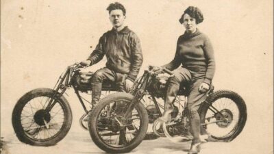 Vintage photograph of two motorcyclists, Moriss and Miss Edith, posing on classic bikes for a circus-themed event.